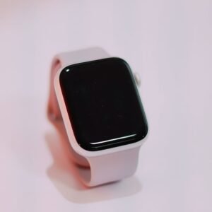 A sleek white smartwatch displayed on a plain surface with a minimalist style.